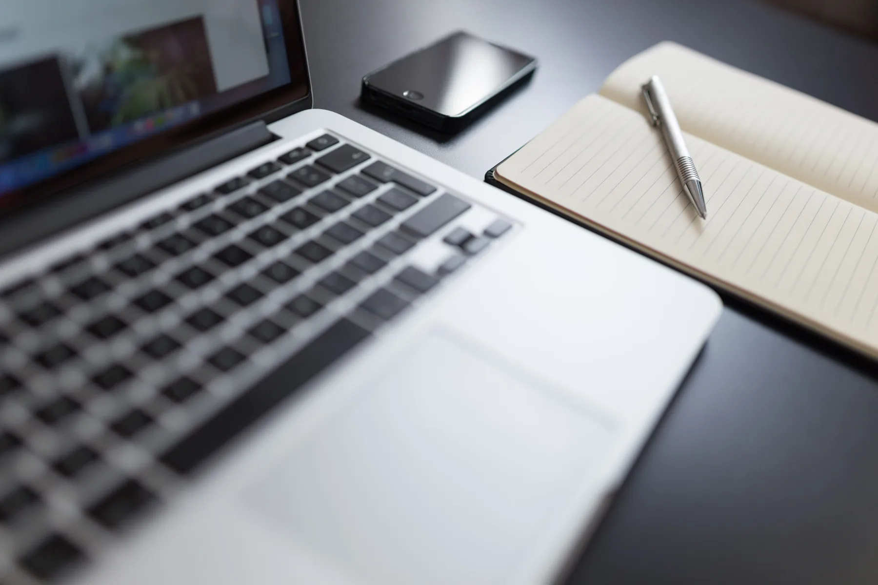 Workspace with a laptop and notebook