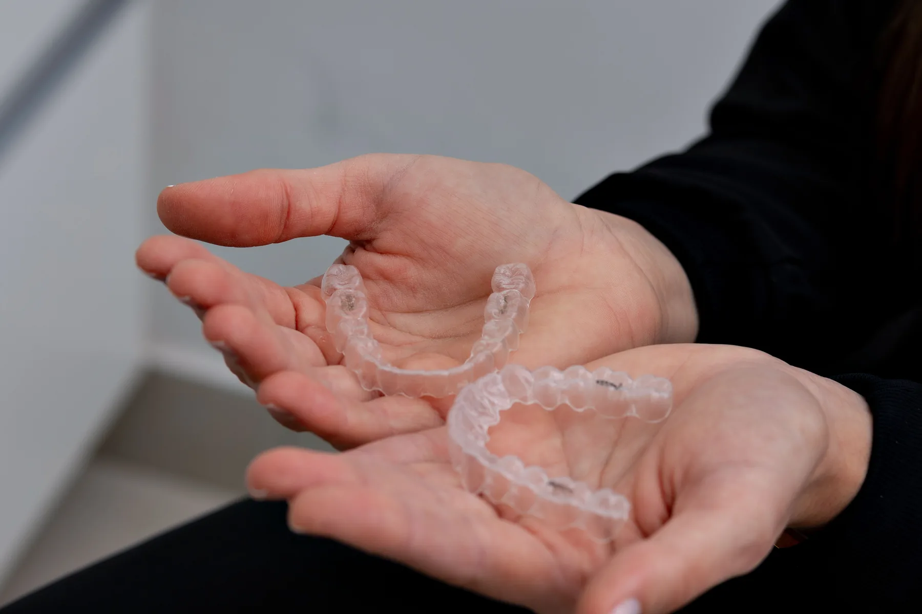 Clear aligners held in a hand